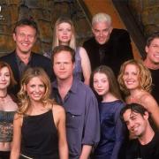 Joss Whedon surrounded by the Buffy cast